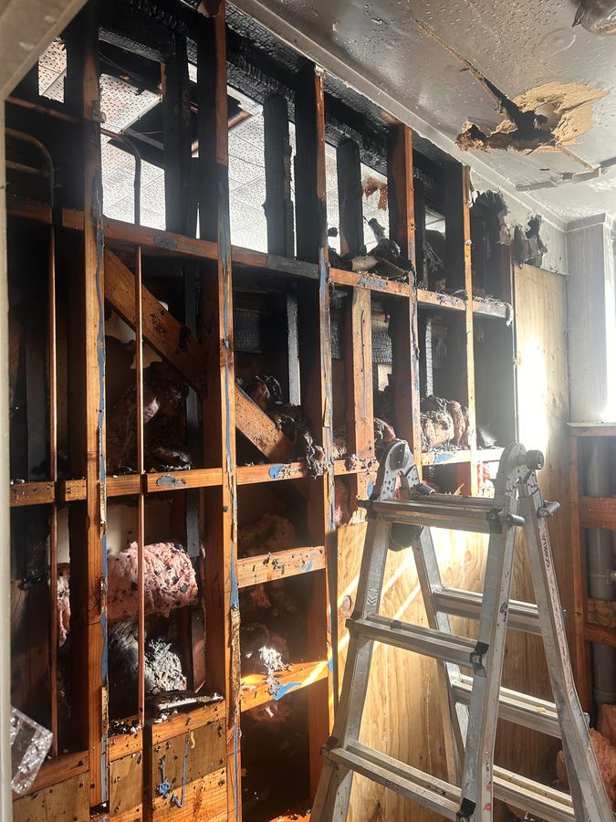 Burned wall framing post-fire — APF insurance remediation project delivery Auckland NZ