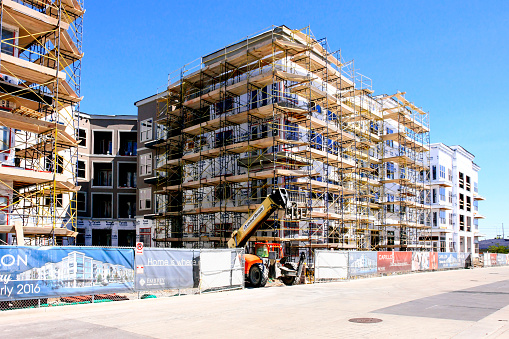 Large commercial building under construction scaffolding — APF $250M retail development South Africa