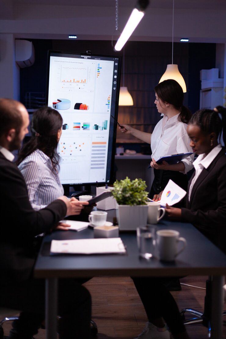 diverse-multi-ethnic-business-teamwork-overworking-office-meeting-room-analyzing-financial-graphs_482257-8164