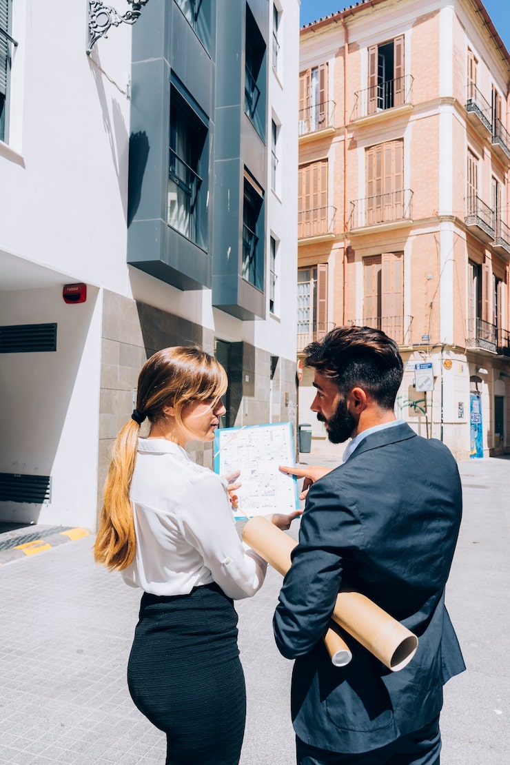 real-estate-agents-talking-about-documents_23-2147650191
