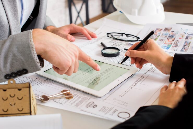 businessmen-analyzing-business-plan-tablet_23-2148252119